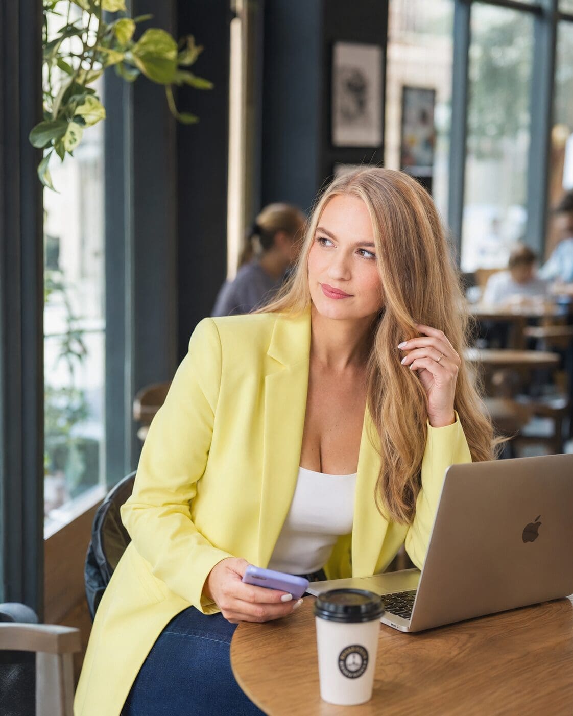 Woman at a coffee shop with phone in hand